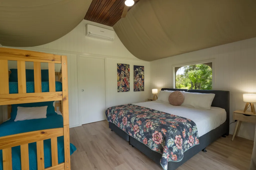 Inside a cabin with a king bed and a set of bunks